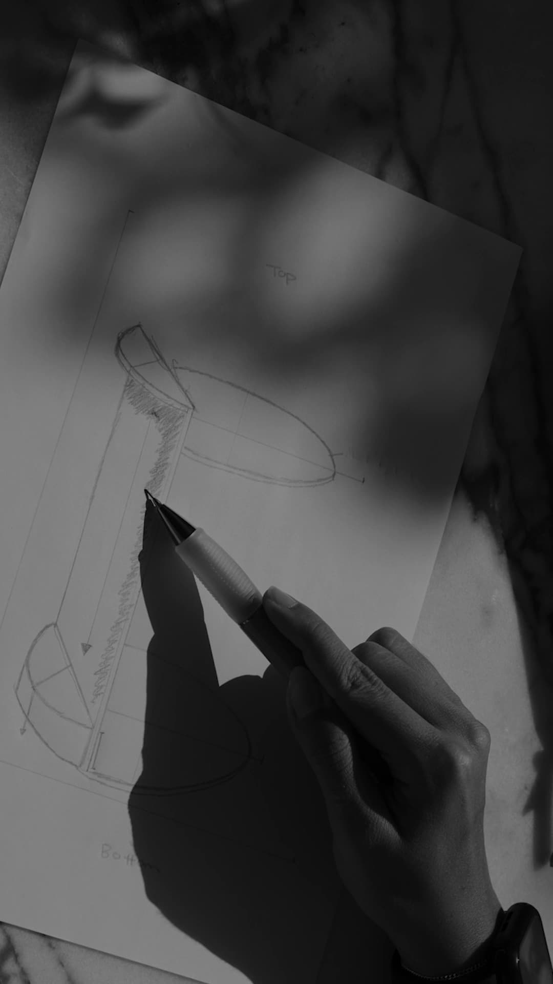 Hand sketching a furniture concept on paper